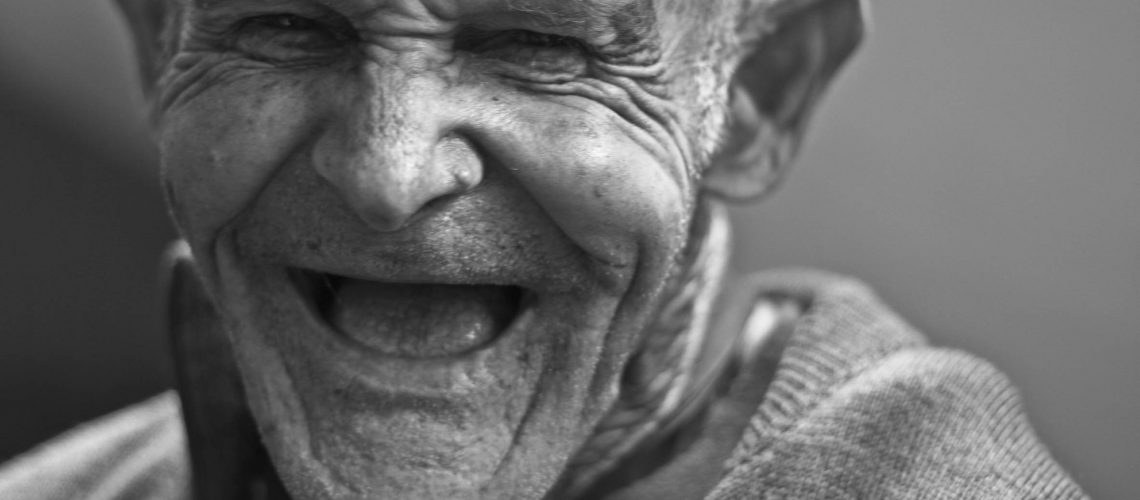 grayscale-photo-of-laughing-old-man-156731